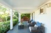 Shaded terrace with wicker seating and garden view at Villa Plumbago, Colombier, St Barthelemy vacation rentals