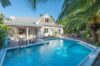 Tropical poolside view of Villa Plumbago with palm trees and terrace, Colombier, St Barts luxury rentals