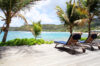 Seafront deck with sun loungers overlooking turquoise waters and palm trees at luxury villa rental in St Barts
