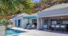 Modern St Barts villa with private pool, sun loungers, and open-plan kitchen and dining area.