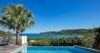 Private infinity pool at a St Barts villa with palm tree and panoramic views of the turquoise Caribbean Sea.