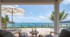 Terrace at a St Barts villa with ocean view, lounge chairs, and drinks set for relaxation