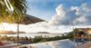 Sunset over the infinity pool with ocean views at a luxury St Barts villa rental