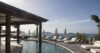 Curved seaside pool with sun loungers and ocean views at a luxury St Barts villa rental