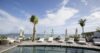 Seaside pool with sun loungers and umbrellas overlooking the ocean at a luxury St Barts villa rental