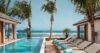 Beachfront infinity pool with sun loungers and palm trees at a luxury St Barts villa rental