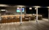 Outdoor bar and lounge area at a St Barts villa with counter seating, dining table, and ambient lighting for evening gatherings.