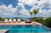 Infinity pool at luxury St Barts villa with sun loungers and panoramic ocean view