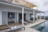 Poolside terrace of St Barts villa rentals with sun loungers and shaded pergola