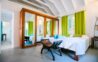 Bright bedroom with king bed, mirrored wardrobe, and garden view at private villa rental in St Barts