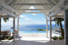 Framed ocean view from shaded terrace with infinity pool at luxury St Barts villa rental.