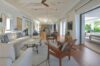 Elegant living room with high ceiling, neutral tones, and open access to terrace in St Barts villa”