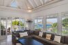 Living room at St Barts villa with sectional sofa and panoramic ocean views through windows