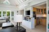 Open-plan living room and kitchen at St Barts villa with modern appliances and terrace access
