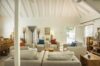 Bright living room with vaulted ceiling, neutral sofas, and wooden accents at a villa in St Barts.