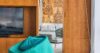 Modern interior of St Barts villa with wood paneling, designer chair, and artistic wall decor