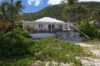 Beachfront villa with terrace surrounded by palm trees in St Barts vacation rental