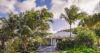 Secluded St Barts villa surrounded by tropical palm trees and lush gardens.