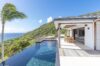 Modern villa with infinity pool, ocean views, and shaded dining terrace in St Barts luxury vacation rental.