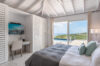 Bright bedroom with terrace access, ocean view, and work desk at St Barthelemy vacation rental