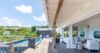 Wooden deck with poolside lounge and hillside views at luxury villa rental St Barts