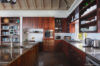 Spacious kitchen with dark wood cabinets and modern appliances inside St Barts vacation rental