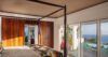 Bedroom with four-poster bed, sliding doors, and ocean view at luxury villa St Barts