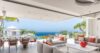 Open-air living room with modern sofas overlooking ocean terrace at St Barts villa rental