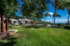 Spacious garden with palm trees and poolside villa at private St Barts vacation rental
