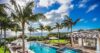 Infinity pool with sun loungers and palm trees at luxury villa rental in St Barts