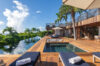 Infinity pool with sun loungers and wooden deck at luxury villa rental in St Barts