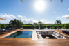 Luxury St Barts villa with sunken lounge and pool deck surrounded by tropical palm trees