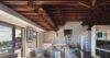 Stylish living room in St Barts villa with exposed wood ceiling and ocean views