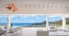 Open-air dining and lounge area at St Barts villa with sweeping ocean views