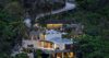 Hillside luxury St Barts villa illuminated at night and surrounded by lush greenery