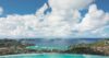 Infinity pool at a St Barts villa with breathtaking panoramic views of turquoise waters, offshore islets, and rolling green hills.
