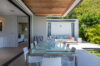 Glass-top dining table on terrace of St Barthelemy rentals with garden views