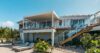 Modern hillside villa with sun loungers, terrace, and outdoor staircase at St Barts vacation rental