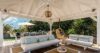 Shaded gazebo with cushioned sofas and hanging chair at St Barts private villa rental