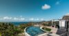 Curved pool with hillside and ocean panorama at St Barthelemy luxury villa rental