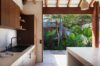 Beautiful modern kitchen seamlessly connected to the outdoors, offering lush natural views
