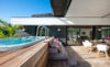 Lounge area situated next to a pool with comfortable seating.