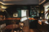 Charming kitchen with dark wood cabinetry, farmhouse sink and warm lighting in St Barts villa rental