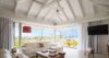 Lounge room with large windows showcasing a beautiful view of the outdoors