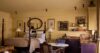 Elegant suite at St Barts villa with four-poster bed, classic artwork, and kitchenette