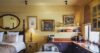 Elegant suite at St Barts villa with kitchenette, wall art, and cozy bedroom corner”