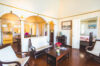 Classic Caribbean living room in a St Barts villa with arched doorways, wooden floors, and vintage décor.