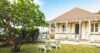 Charming Caribbean-style villa in St Barts with veranda, garden, and sun loungers.