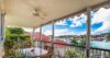 Covered terrace dining area at a St Barts vacation rental overlooking Gustavia harbor and red rooftops.