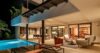 Evening terrace of a St Barts luxury villa with illuminated pool, open-air lounge, and tropical backdrop.